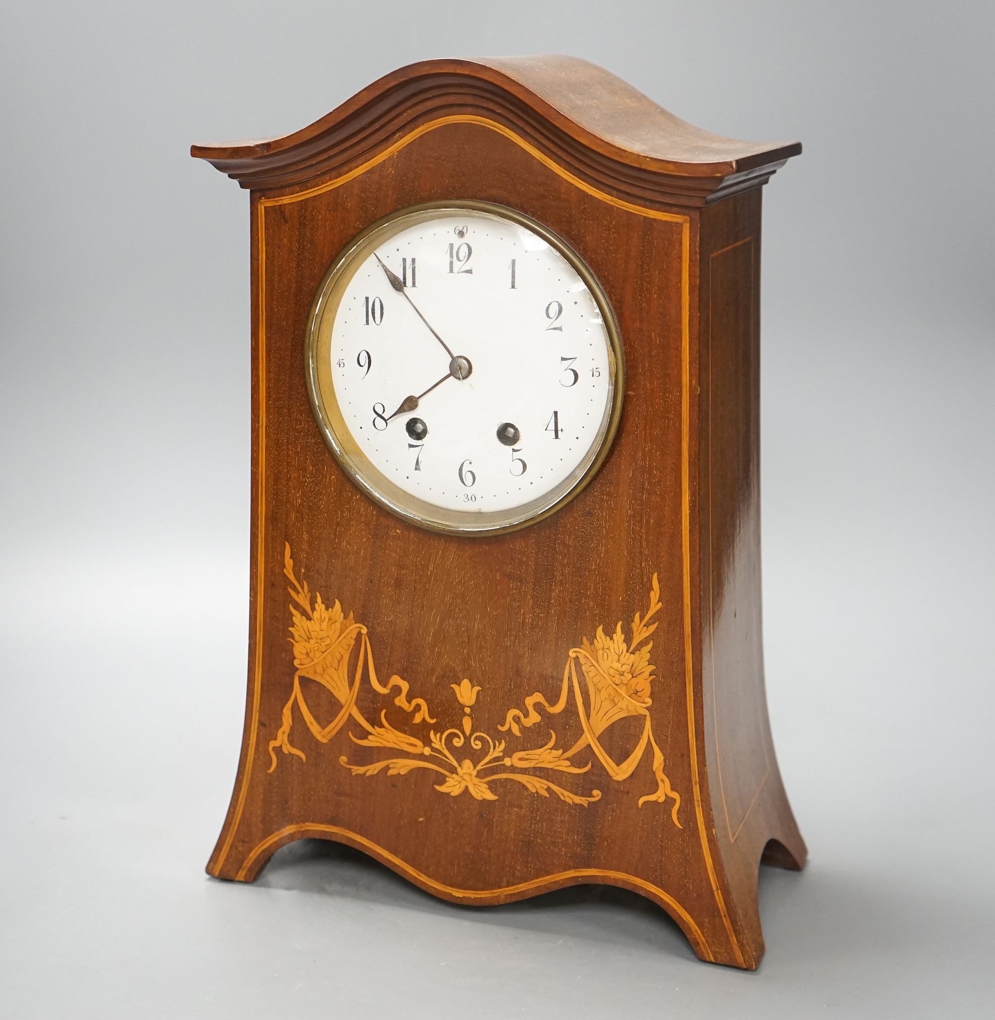 An Edwardian inlaid mahogany mantel clock with French gong-striking movement, 39cm.